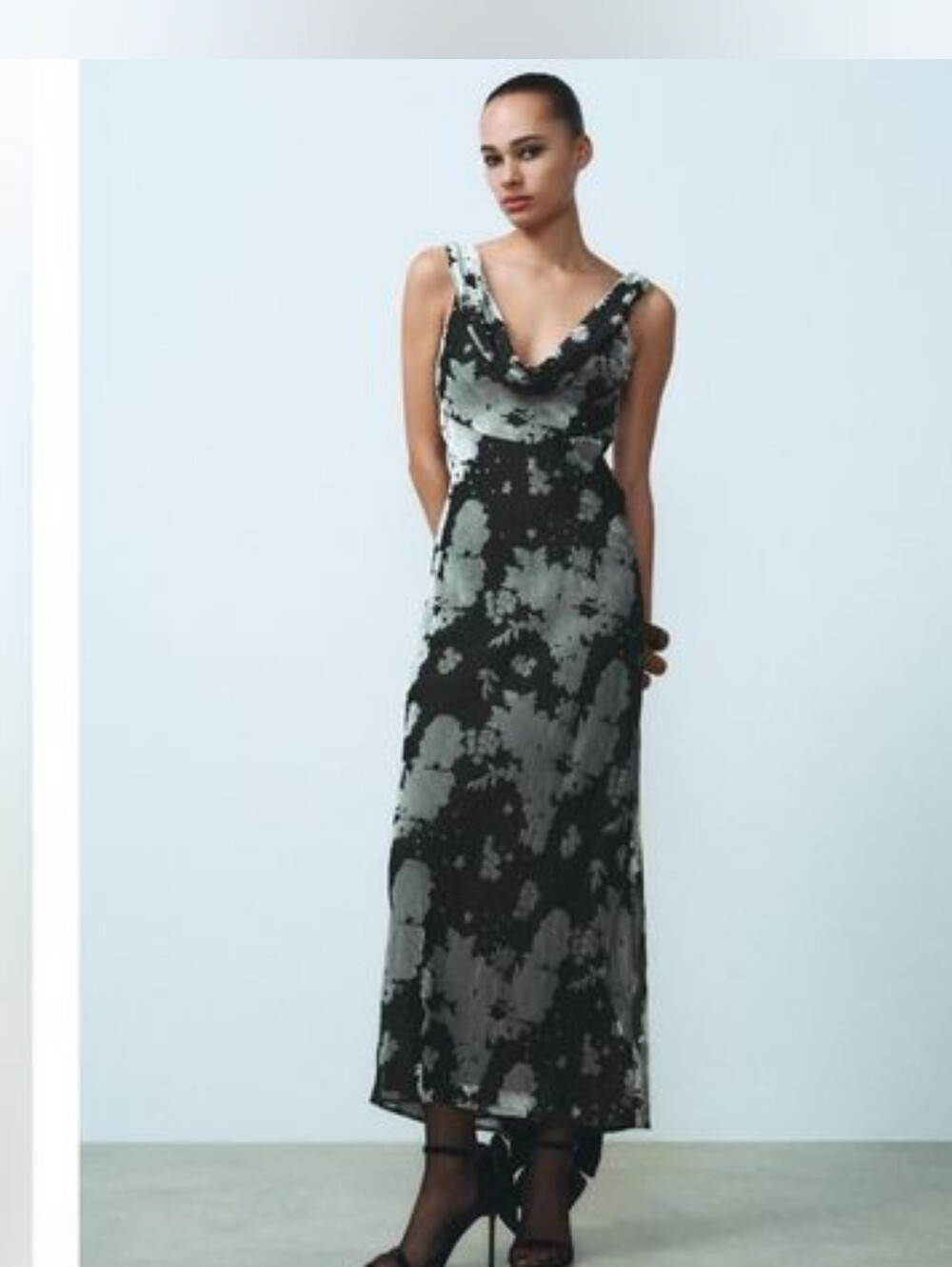 This is a Zara floral maxi dress in black and grey with a draped neckline.
